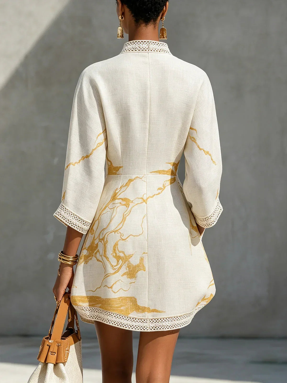 Renata - Short lace dress with golden print and deep V-neck